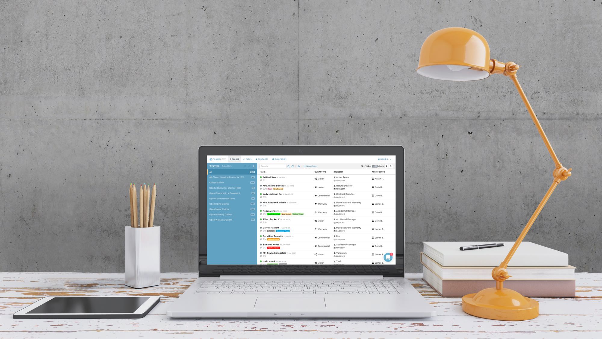Claimable claims software interface displayed on a laptop in a modern office setting
