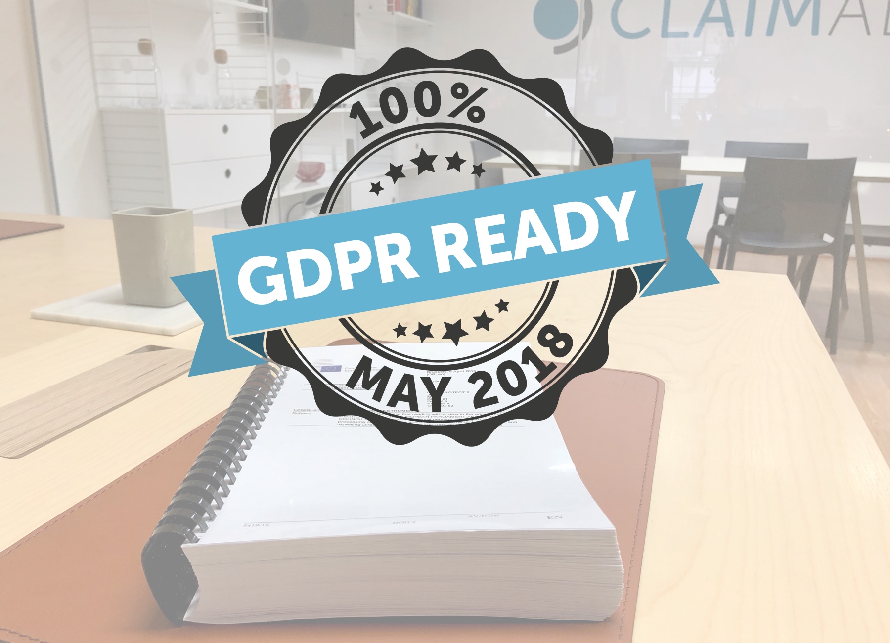 The printed GDPR legislation on a desk in the Claimable office and a GDPR-ready badge.